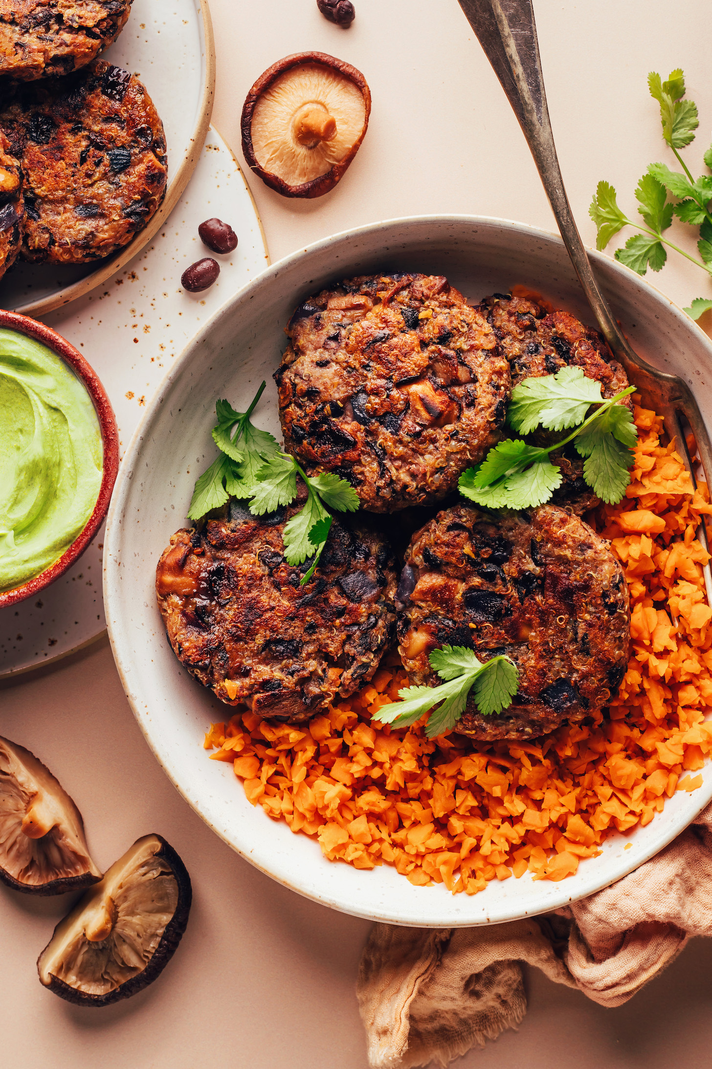 Spicy mushroom black bean fritters in a bowl with sweet potato rice and cilantro