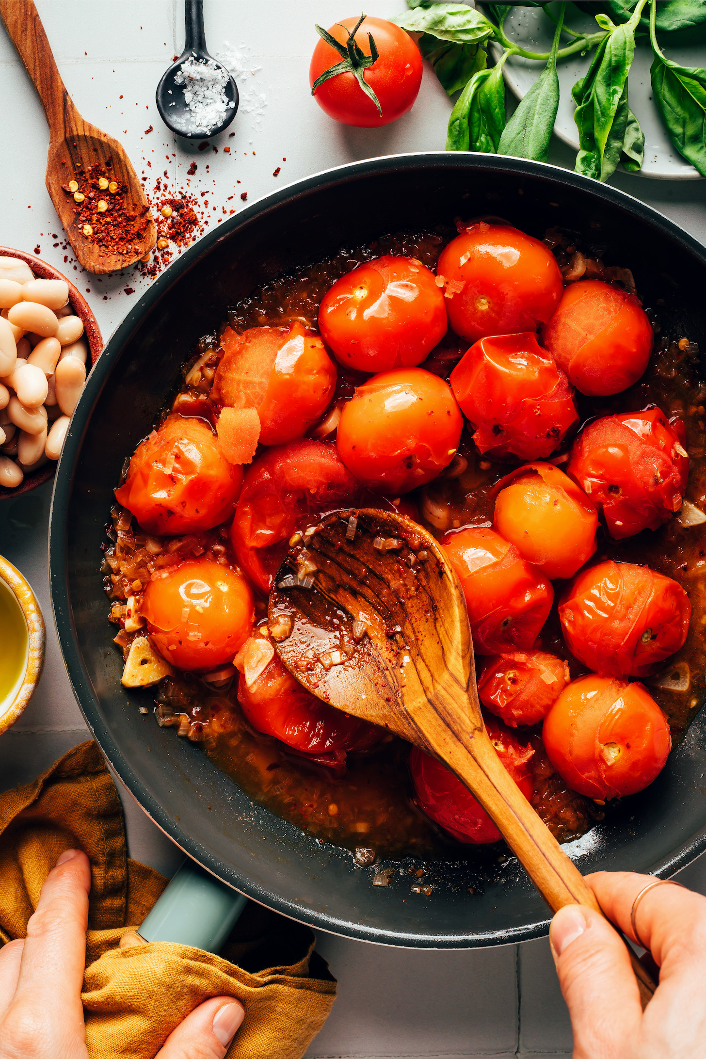 Burst cherry tomatoes in a skillet