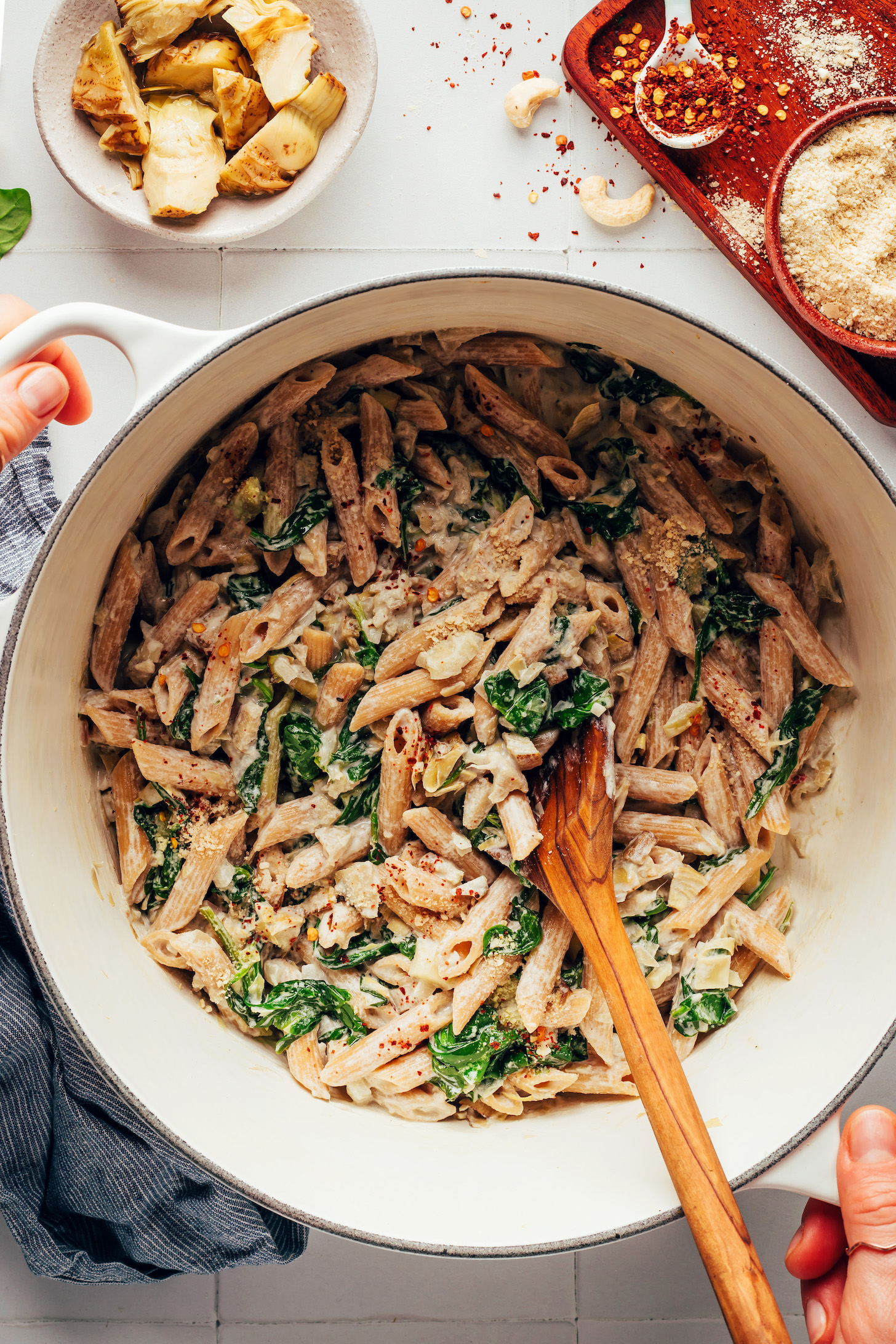 Pot of vegan spinach and artichoke dip pasta