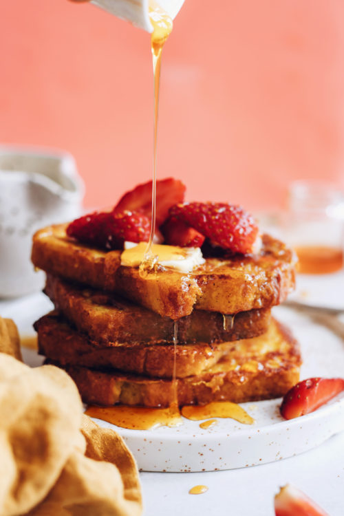 Drizzling syrup over sliced of vegan French toast
