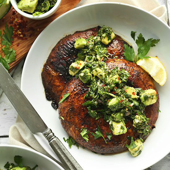 Plate with two Portobello Steaks topped with Avocado Chimichurri