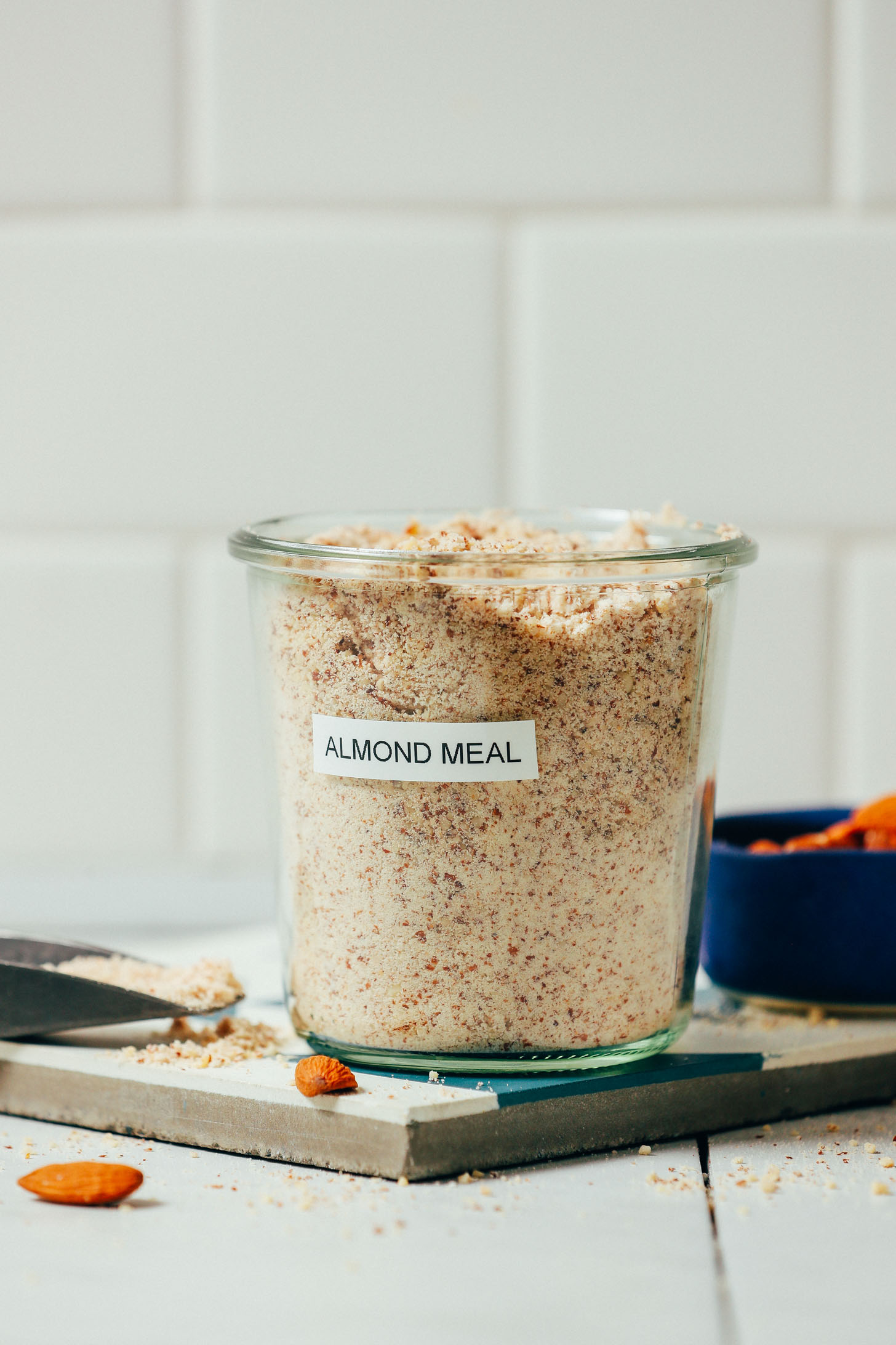 Jar of homemade almond meal on a tile