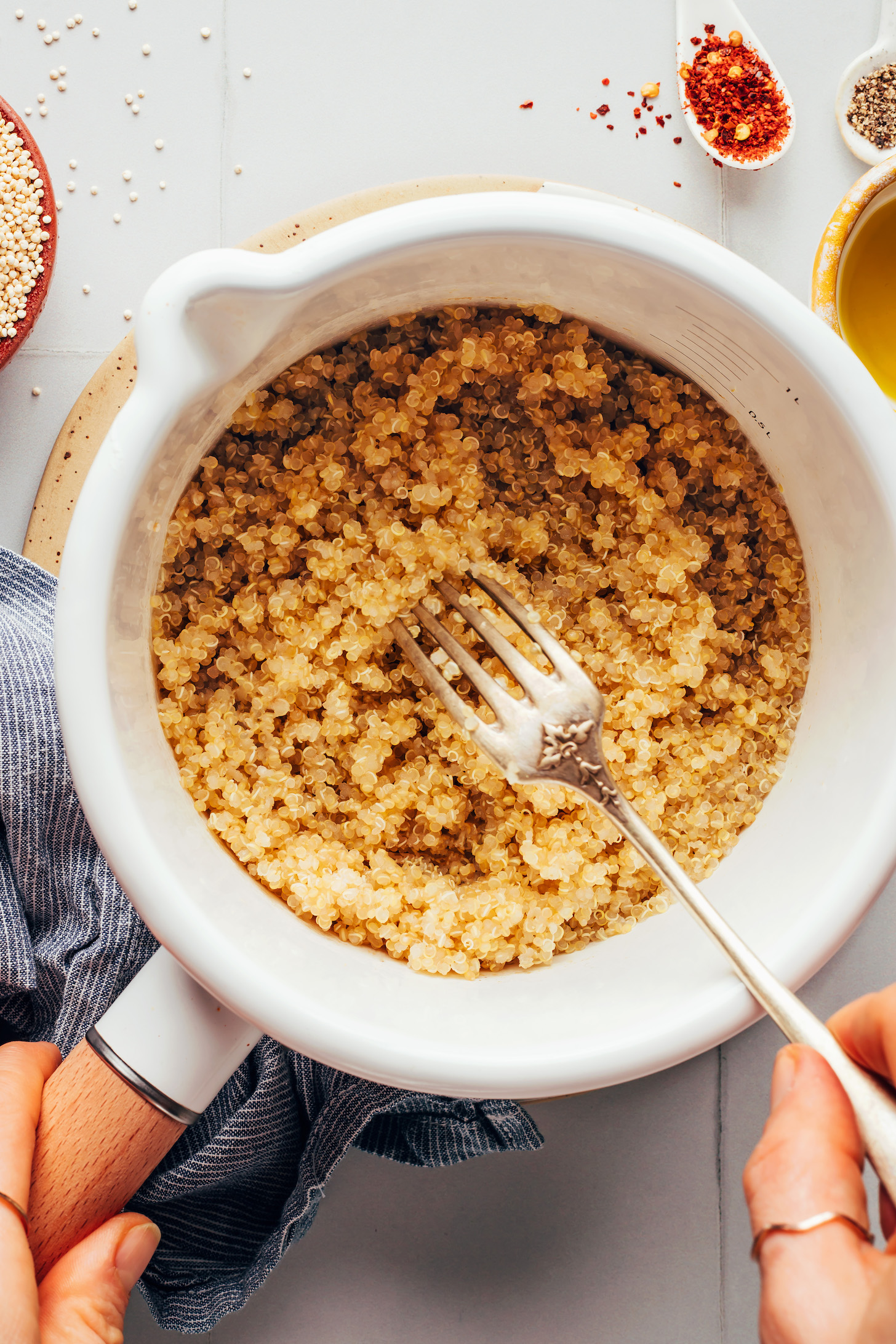 Fluffy quinoa with a fork in a saucepan