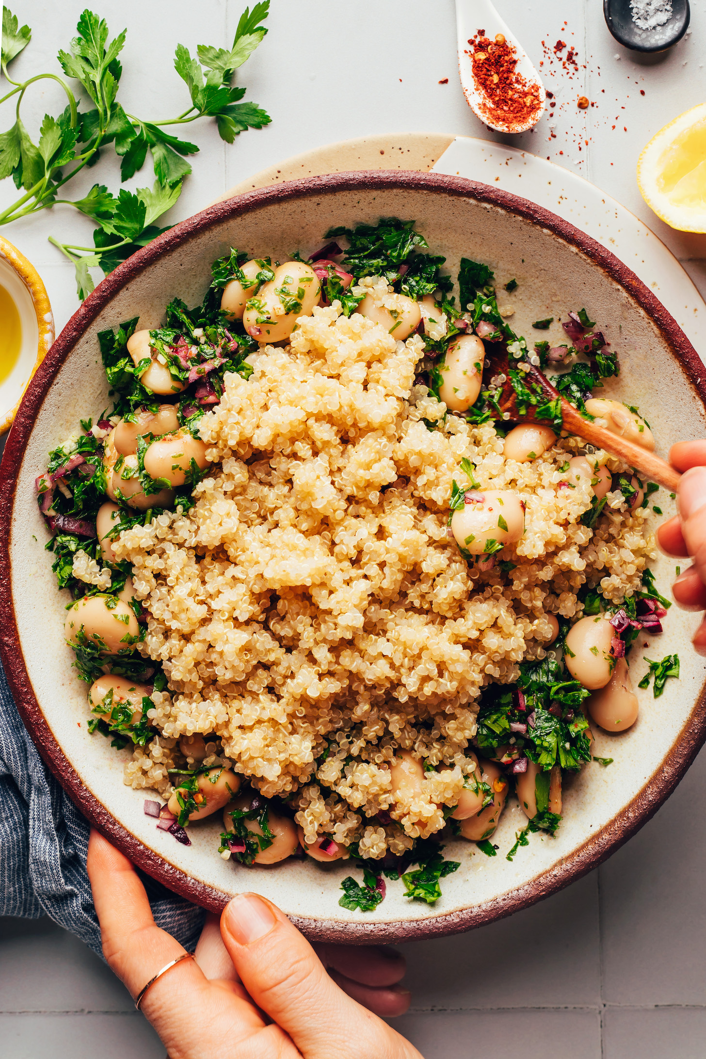 Stirring cooked quinoa with other salad ingredients