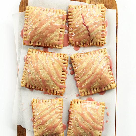 Plate of homemade Vegan Strawberry Rhubarb Pop-Tarts drizzled with pink glaze