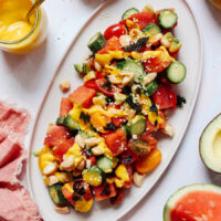 Platter of spicy watermelon cucumber salad drizzled with mango vinaigrette