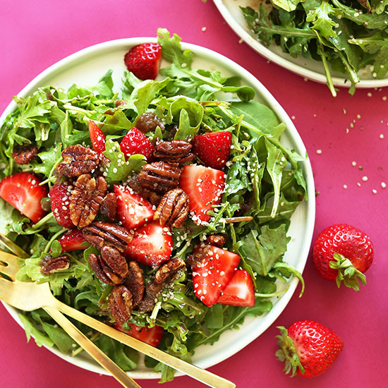 Big plate of Strawberry Arugula Salad on a pink background